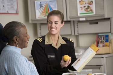 United States Public Health Service Commissioned Corps officer speaking about nutrition with a patient