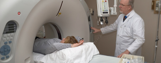 Radiology technician assists a patient into a 64-slice CT Scanner for diagnostic testing.