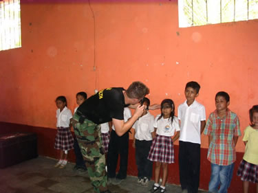 LCDR Paul DeWitt, an optometrist, evaluates local school children while at the Escuela Santa Isabel in Guatemala.