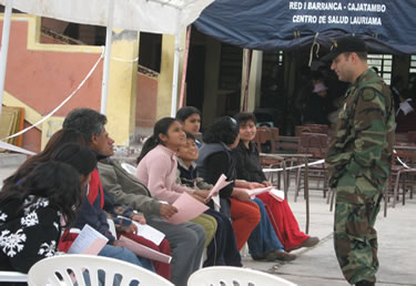 While in Peru, LT Jaime Regal, an environmental health officer, educates patients on appropriate dental care techniques at the Huacho clinic.