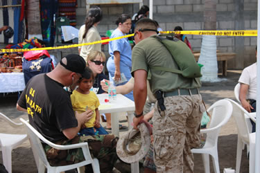 LCDR David Campbell is a Commissioned Corps nurse practitioner assigned to the Federal Bureau of Prisons at U.S. Penitentiary at Leavenworth. LCDR Campbell is shown providing care to one of the 45 pediatric patients whom he saw during pediatric care day at Escuela de Las Pampas, Guatemala.