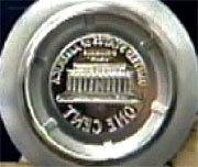 Image shows close-up view of a coin-stamping die.