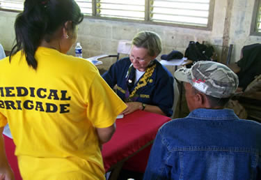Photo: LT Laurel Christians, a nurse practitioner, fills out a prescription for a patient during a Pacific Partnership 2008 medical civic action program at the Nuro School in the Autonomous Region of Muslim Mindinao.