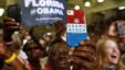 A supporter uses her personalized mobile phone to take a picture of U.S. President Barack Obama as he speaks at a campaign event at the Florida Institute of Technology in Melbourne, Florida, September 9, 2012