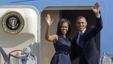 President Barack Obama and first lady Michelle Obama wave as they board Air Force One before leaving Charlotte, N.C., after the Democratic National Convention, Sept. 7, 2012. 