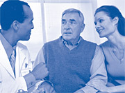 Image of an old man accompanied by his daughter consulting with doctor