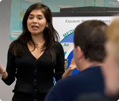 a woman speaking to a crowd