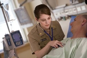 Nurse using stethoscope to check patient heart beat