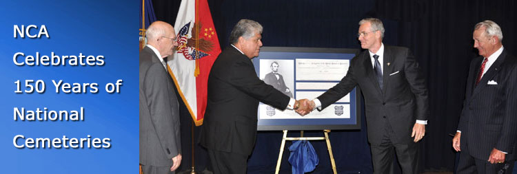 Under Secretary Muro and Deputy Secretary Gould shake hands after unveiling a framed copy of the Omnibus Act of 1862 establishing national cemeteries.