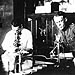 In 1910, researchers worked at a U.S. Public Health Service laboratory equipped with a bunsen burner, microscope, and petri dishes.