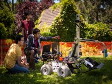 Teammates from the University of Waterloo, Canada, team work with their robot on the practice field at the Sample Return Robot Challenge.