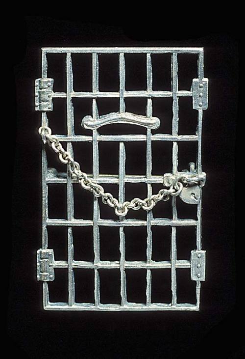 Image description: These small silver &#8220;Jailed for Freedom&#8221; pins in the shape of prison doors with heart-shaped locks were presented to suffragettes in celebration of their release from prison at a meeting in December 1917.
The women, members of the National Woman&#8217;s Party, had been arrested outside the White House for protesting against the government&#8217;s failure to pass a constitutional amendment giving women the right to vote. They are considered to have been the first people to ever picket the White House.
In June 1917, the D.C. police began arresting picketers for obstructing sidewalk traffic. Over 150 women were sentenced to terms ranging from 60 days to 6 months in the Occoquan Workhouse. When their demands to be treated as political prisoners were ignored, they went on hunger strikes and were forcibly fed. The publicity surrounding their ordeal generated public sympathy for the suffragists and their cause. Learn more about the National Woman&#8217;s Party.
Image courtesy of the National Museum of American History.