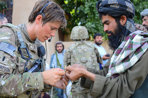 Image description: An Afghan farmer shows a diseased plant to U.S. Army 1st Lt. Tara Robertson, a Minnesota Army National Guardsman serving with the Zabul Agribusiness Development Team in Zabul province, Afghanistan. The team features Minnesotan citizen-soldiers with expertise in agribusiness, such as veterinarians, hydrologists, and livestock specialists.
Image by Lt. Col. Daniel Bohmer, courtesy of the Department of Defense.
