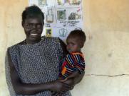 A woman and her child wait to see a health worker 