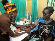 A health worker examines a women in South Sudan