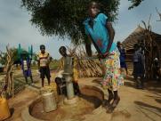 A child pumps water in Kanajak, South Sudan