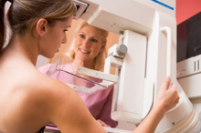 Photo of a woman getting a breast exam.