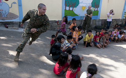 Image description: In Sihanoukville, Cambodia, Sgt. Marcos Bustos joins in the fun during a community service event at the Help the Cambodian Children Goodwill Center.  Sgt. Bustos is assigned to the 11th Marine Expeditionary Unit and aboard the USS Pearl Harbor.
Photo by U.S. Navy Photo by Mass Communication Specialist 2nd Class Dominique Pinerio