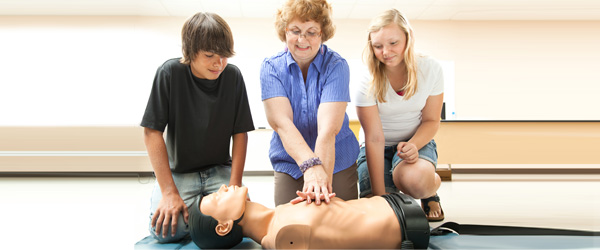 A CPR class training with resuscitation dummies