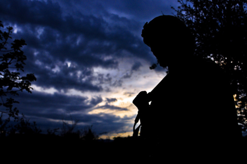 Image description: U.S. Army Staff Sgt. Charles Stokes pauses while on patrol in a local village near Combat Outpost Terezayi on April 10.
Photo by U.S. Army Spc. Eric-James Estrada