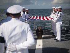 US Navy Lieutenant Commander Paul Nagy, USS Philippine Sea, and Carol Armstrong, wife of Neil Armstrong, commit the cremated remains of Neil Armstrong to sea during a burial at sea service held onboard the USS Philippine Sea (CG 58), Friday, Sept. 14, 2012, in the Atlantic Ocean.