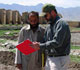 Drew Adam of USDA shares agricultural info with an Afghan farmer.