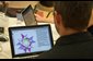 Photo of teacher John Sheridan viewing Geometer's Sketchpad on a laptop.