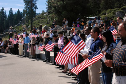 participants of the USCIS and NPS with flags