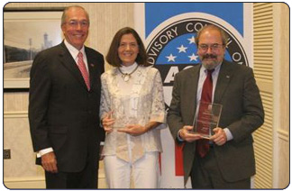 John L. Nau, III, chairman of the Advisory Council on Historic Preservation (left),  presents the Chairman's Award for Federal Achievement in Historic Preservation to Deputy Secretary of the Interior Lynn Scarlett (center), and Under Secretary of Agriculture Mark Rey. 