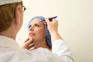 plastic surgeon examining a woman