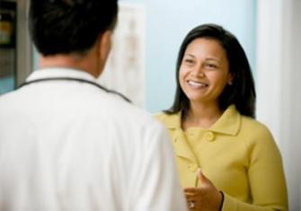 Photo of a woman speaking with her doctor.