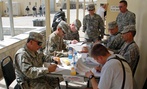 Soldiers filling out voter absentee ballots at Camp Phoenix in Kabul, Afghanistan.