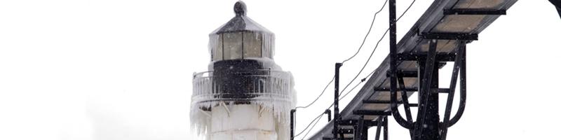 January 10th, 1994. A light house and bridge are completely covered in ice and snow.