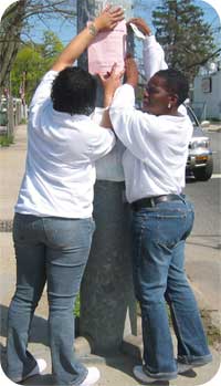 two women posting flyer