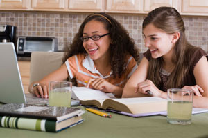 two girls looking at a laptop