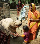 During a campaign in India a child’s pinkie finger is marked by a vaccinator signifying that polio vaccination has received.