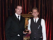 Tom Shortridge and Scott Bednar holding their Emmy statuette