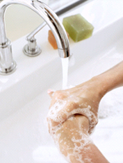 Hands being washed under a faucet