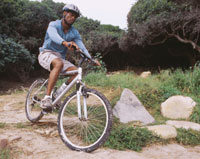 Photo: Man riding bicycle with helmet on