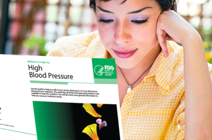 Woman reading pamphlet on High Blood Pressure