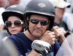 Todd Palin, husband of Sarah Palin, former governor of Alaska, adjusts his helmet as his daughter Piper sits behind him before taking part in the Rolling Thunder motorcycle ride to honour U.S. veterans in Washington May 29, 2011. REUTERS/Joshua Roberts