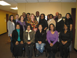 Fourteen women and four men from the Detroit Champions take a picture together.