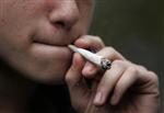 A young man smokes marijuana before the 10th annual "Marijuana March" in downtown Toronto May 3, 2008. REUTERS/Mark Blinch