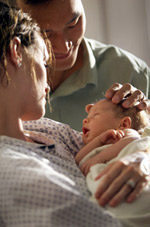 Photo: Couple holding a baby