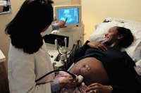 Photo: pPegnant woman looking at ultrasound image