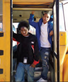 This is a photograph of teenage students Daevion Caves and Jordan Atkins exiting a school bus.