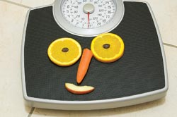 a scale with fruit in the shape of a smile
