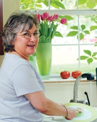 A woman washing veggies.