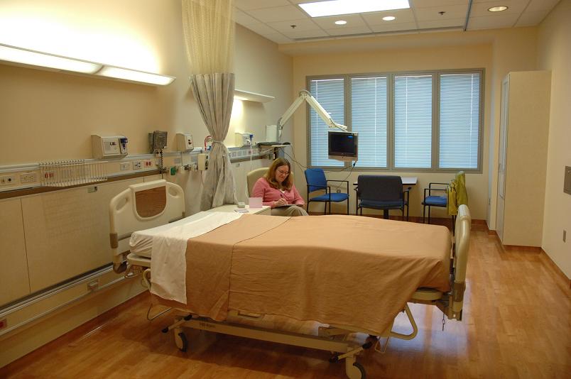 A patient completeing a questionnaire in her room