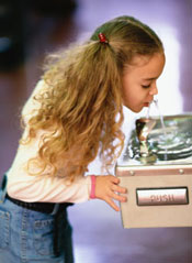 photo of a girl at a water fountain